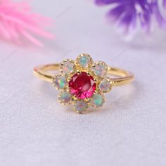 Vintage Red Ruby Opal Engagement Ring Art Deco Ruby Wedding Band 18k Solid Yellow Gold Ruby and Opal Cluster Ring October Birthstone Ring Welcome to A1Jewells Experience stunning jewelry which compliments your style everyday, All the items in my shop are hand made items and are crafted by our Master Goldsmith in our workshop, We pay a lot of emphasis on the making of the ring and we always assure you that we will provide best quality products every time toy you, Detailed description of the product Main Stone: Ruby   Main Stone Size: 4.5mm Main Stone Color: Red Main Stone Shape: Round Birthstone Month: July Secondary stone: Opal Secondary stone Color: White Secondary stone Size: 2.5mm Other Available Stone : Sandstone, Ruby, Sapphire, Emerald, Alexandrite, Diamond, Green Sapphire, Turquoise Pink Ruby Halo Ring Perfect For Gift, Pink Ruby Ring With Halo For Gift, Gift Pink Ruby Halo Ring, Gift Pink Halo Ruby Ring, Pink Ruby Ring With Halo Design, Round Ruby Flower Promise Ring, Flower Shaped Multi-stone Wedding Jewelry, Flower-shaped Multi-stone Wedding Jewelry, Yellow Gold Multi-stone Flower Ring For Wedding