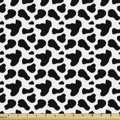 a black and white animal print fabric with large spots on the front, in an allover pattern