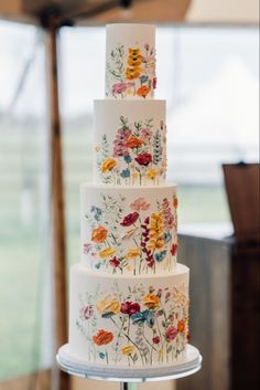 a wedding cake with flowers painted on it