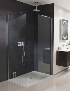 a bathroom with a walk in shower next to a sink