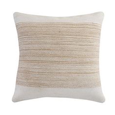 a beige and white pillow with stripes on it's side, in front of a white background