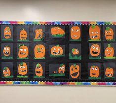 a bulletin board with pumpkins and faces on it's sides, all decorated in different colors