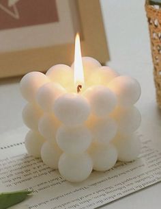 a white candle sitting on top of a table