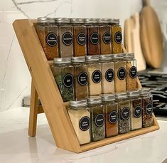 a wooden spice rack with spices on it