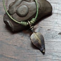 This is a simple, light to wear iron pendant of a small leaf. Each leaf has been indivudally forged by hand. The surface of the pendant retains the hammer marks and the texture or both my anvil and the hammers I use.  The stem of the leaf has been twisted onto itself to form the loop.  You have a choice of cord colour and type. The main photo shows the pendant on a moss green leather cord. The cord is tied by two sliding knots that allow the wearer to choose how high they want to wear the pendan Medieval Hand Forged Necklaces As Gift, Medieval Style Hand Forged Necklace, 6th Wedding Anniversary, Iron Jewelry, Iron Pendant, Hand Forged Iron, Leather Finish, Small Leaf, Forged Iron