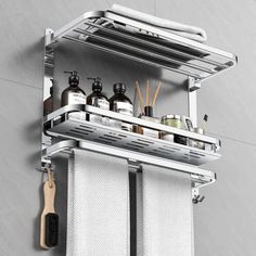 a bathroom shelf with two towel racks holding soaps, toothbrushes and lotion