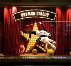 a display window with an image of a man performing on top of a star in front of a red curtain