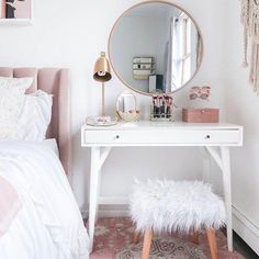 a white desk with a mirror, stool and other items sitting on top of it