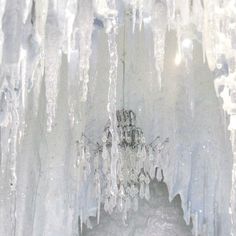 an ice cave with icicles hanging from the ceiling