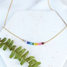 I call these little beaded necklaces "Color Flights" - almost like a mood ring for your neck! Feeling like a rainbow today? Perfect! Here is the necklace for you. A hand selected grouping of glass beads in rainbow colors are carefully strung on a dainty gold filled cable chain. Beaded area measures a little over 1" across. Necklace Details all metals are gold filled (nickel free) adjustable with 16" to 18" length handmade in Nashville, TN Adjustable Rainbow Necklace With Colorful Beads, Everyday Rainbow Jewelry With Round Beads, Everyday Rainbow Round Bead Jewelry, Rainbow Crystal Necklaces With Colorful Beads For Gift, Everyday Rainbow Beaded Jewelry, Handmade Rainbow Necklaces For Everyday Wear, Handmade Rainbow Necklaces For Everyday, Handmade Rainbow Necklace For Everyday, Rainbow Necklaces With Spacer Beads For Jewelry Making