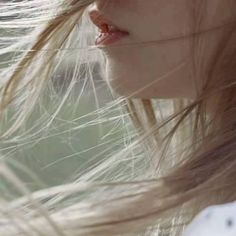 a woman with her hair blowing in the wind