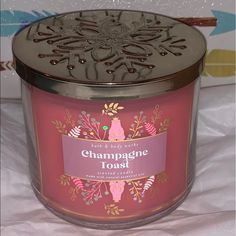 a candle that is sitting on top of a white sheet with the words champagne toast in it