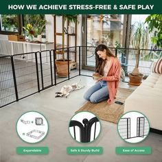 a woman sitting on the floor in front of a dog gate and playing with her cat