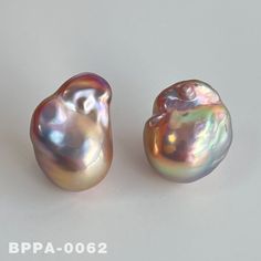 two different types of pearls on a white surface