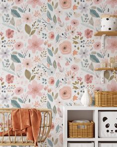 a baby's room with floral wallpaper and pink flowers on the walls,