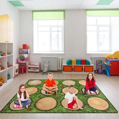 three children sitting on the floor in a play room