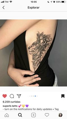 a woman with a lion tattoo on her back is holding her lower back and the upper half of her body