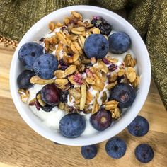 a bowl filled with yogurt, blueberries and granola