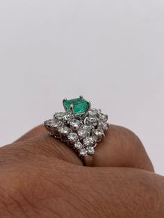 Stunningly gorgeous, Emerald & Diamond Ring set in Platinum. Handmade. Beautiful quality piece of jewelry. Approximately 2.20 ct. in Diamonds, Emerald is nice color & measures 1.15 ct. Diameter of ring is 19mm, size 6 but can be sized. Circa 1950's Luxury Platinum Cluster Emerald Ring, White Gold Emerald Ring With Brilliant Cut Cluster, White Gold Cluster Emerald Ring With Brilliant Cut, Luxury Cluster Emerald Ring With Diamonds, Cluster Green Emerald Ring In Platinum, Green Emerald Cluster Ring In Platinum, Green Platinum Emerald Ring With Cluster Shape, Platinum Cluster Emerald Ring, Luxury Emerald Cluster Ring With Vvs Clarity