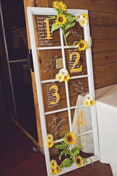 an old window decorated with sunflowers and flowers