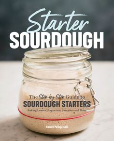 a mason jar filled with sand sitting on top of a white counter next to the words, starter sourdough