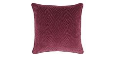 a dark red pillow on a white background