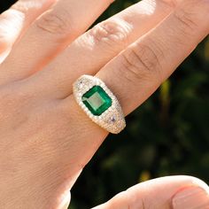 Beautifully crafted from 14K yellow gold, this stunning bombe ring features an emerald-cut emerald centerpiece surrounded by shimmering pave diamonds with trillion cut white diamonds on each side. An exquisite choice for special occasions, this classic glamour piece is sure to make a statement. 14K yellow gold Emerald (Emerald cut); Diamonds, approximately 2.98 carats Dimensions: 14mm x 12mm Size 8 One of a kind Designed in California Style number: SRG086-8 Luxury Trillion Cut Diamond Emerald Ring, Luxury Trillion Cut Emerald Diamond Ring, Emerald Cut Diamond Ring With Pave Setting, Luxury Emerald Cut Cubic Zirconia Emerald Ring, Bombe Ring, Classic Glamour, Stacked Necklaces, California Style, Shiny Things