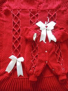 a red sweater with white bows on it