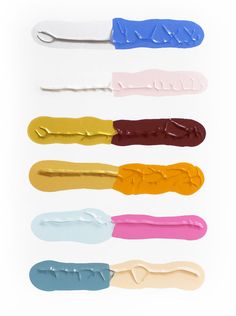 six different colors of toothbrushes on a white background