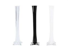 three tall glass vases sitting next to each other on a white surface with no one around them