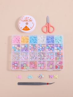 the craft kit is filled with beads, buttons and scissors