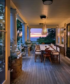 an outdoor table and chairs on a porch