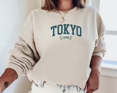 ✨Basic Info✨ This listing is for a sweatshirt that says 'TOKYO JAPAN' on the front! The color of the sweatshirt is 'Sand', but contact me if you would like to see a different color! I also offer sweatshirts with other cities, but let me know if there is a city you don't see that you would like me to make! Make sure you check out our other great products like our Potions Collection T-Shirts :) ✨Shirt and Sizing Info✨ All VillainessLabs crewneck sweatshirts are printed on a Gildan 18000 Unisex Hea Trendy Crew Neck Cream Sweatshirt, Trendy Beige Crew Neck Sweatshirt, Cream Hoodie With Letter Print And Crew Neck, Cream Crew Neck Hoodie With Letter Print, Sweat Shirts, Greek Life, Tokyo Japan, Crewneck Sweatshirt, Sweat Shirt