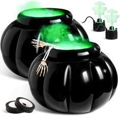 two black vases with green lights on them and one has scissors next to it