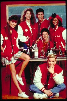 a group of people in red shirts posing for a photo