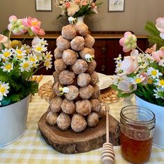 a table topped with lots of doughnuts and flowers