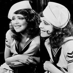 two women in sailor uniforms sitting next to each other