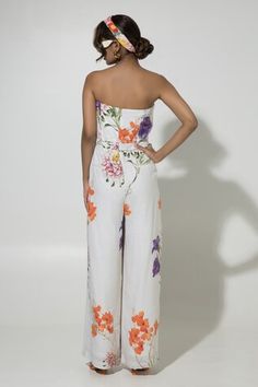 White linen jumpsuit with floral print. - Aza Fashions Spring Summer Strapless Jumpsuit With Floral Print, Spring Strapless Jumpsuit With Floral Print For Summer, Spring Strapless Jumpsuit With Floral Print, White Strapless Sleeveless Jumpsuit For Spring, Fitted Strapless Floral Jumpsuit For Summer, Spring Floral Print Strapless Sleeveless Jumpsuit, Spring Floral Print Strapless Fitted Jumpsuit, White Strapless Jumpsuit For Spring Beach Outing, White Strapless Sleeveless Jumpsuit For Beach