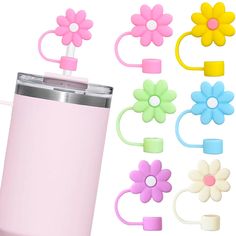 a pink cup with flowers on the side next to some hair clips and other accessories