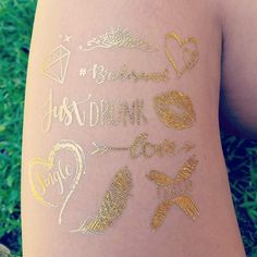 the back of a woman's leg with gold glitter tattoos on her arm and chest