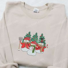 Three Snowmen Christmas Trees Embroidered Shirt, Christmas Embroidered Hoodie, Best Gifts For Family Welcome to Tinicloset, the enchanting realm of custom embroidered apparel that’s designed to infuse your holiday season with warmth, joy, and a touch of festive magic. Our commitment to crafting unique and delightful pieces is at the heart of our mission, and we take great pride in offering an array of creations, including our captivating Three Snowmen Christmas Trees embroidered shirt and White Embroidered Sweatshirt For Winter, Embroidered Apparel, Snowman Christmas Tree, Rosy Cheeks, Embroidered Clothes, Embroidered Hoodie, Best Christmas Gifts, Cozy Christmas, Great Love