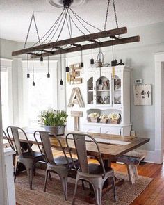 a dining room table with chairs and a chandelier hanging from it's ceiling