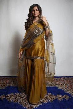 Burnt gold and grey kurta in dupion silk base. Comes with georgette sharara and an organza dupatta having dual coloured patchwork, including zari and sequins hand embroidered chakra motifs.
Component: 3
Pattern: Embroidered
Type Of Work: Zari, Sequins
Neckline: V Neck
Sleeve Type: Short
Fabric: Kurta : Dupion Silk, Sharara : Georgette, Dupatta : Organza 
Color: Gold
Other Details: 
Embroidered neckline and borders on kurta
Closure : Sharara : Fixed belt at front and elastic at cack, Opening on t Silk Kameez, Gharara Designs, Sharara Designs, Pakistani Dresses Casual, Pakistani Fashion Party Wear, Traditional Indian Outfits, Party Kleidung, Simple Pakistani Dresses, Designer Party Wear Dresses