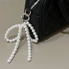 Material : PEARL Pearl Type : Simulated-pearl Metal color : Silver Style : TRENDY Metals Type : zinc Alloy Item Type : KEY CHAINS Fine or Fashion : fashion Gender : Women Fashion Pearl Bowknot Keychain Pendant Sweet Cute Hanging Decorations Keyring Charm for Purse Bag Backpack Handbag For Women WHAT ABOUT REFUND?   Fast refund,100% Money Back Guarantee. If your product is defective or doesnt work properly, let us know and well send you a replacement one. We believe in our products so much that we offer a 30-day No-Hassle refund policy. If youre unhappy about your purchase, send us the product back and well refund your money immediately. Metal Bow, Shoe Buckle, Pearl Shoes, Bow Pendant, Bag Decoration, Bow Shoes