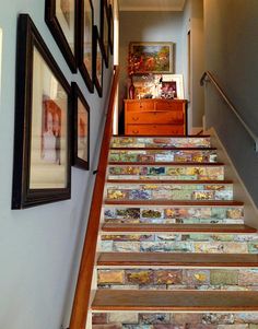 the stairs are decorated with pictures and paintings