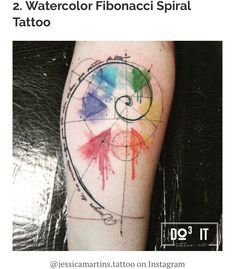 a colorful tattoo on the arm with watercolor fibonacci spiral