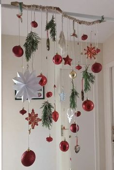 christmas decorations hanging from the ceiling in a room