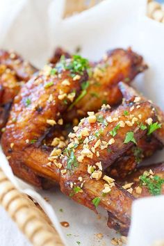 chicken wings covered in sesame seeds and garnished with parsley