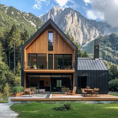 a house in the mountains is surrounded by greenery and wooden furniture, with mountain views behind it