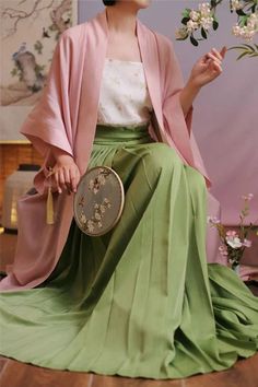 Step into the essence of spring with beautiful shades of green and pink. This ensemble includes a simple and lightweight jacket inspired by artifacts from the renowned Changgan Temple, paired with a breezy ramie plant moxiong tank top and a flowing baidiequn skirt. The Ou Lu 鸥鹭 Egret Song Dynasty Set is perfect for celebrating the vibrancy of spring. Drawing inspiration from the artifacts of Changgan Temple 长干寺, this jacket features a long silhouette, wide sleeves, and slits on the sides for ven Green Outerwear With Kimono Sleeves For Spring, Hanfu Men, Spring Drawing, Modern Hanfu, Song Dynasty, New Chinese Style, New Chinese, Green And Pink, Wide Sleeves